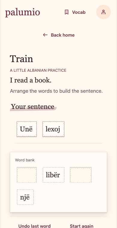 An Albanian sentence activity with torn paper word tiles